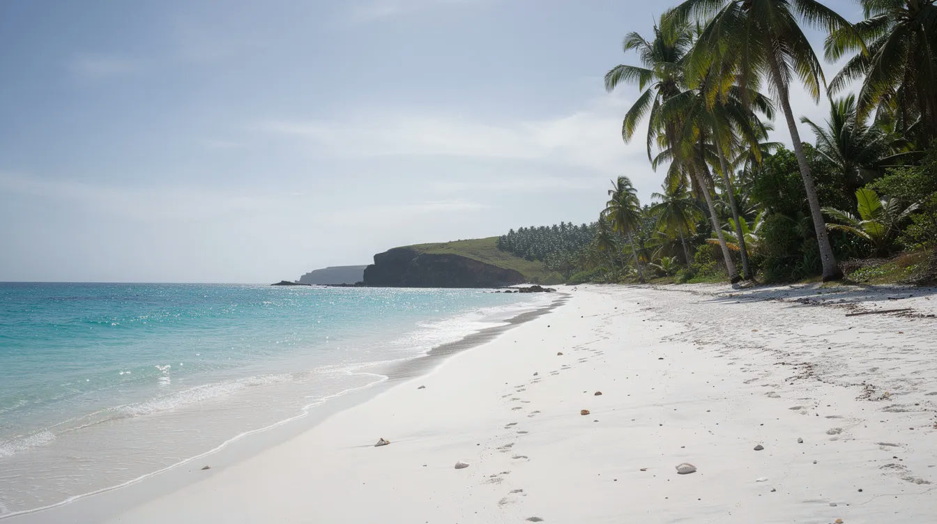 A serene tropical beach scene showcases white sand and turquoise water, with palm trees gently swaying in the wind along the Kenyan coast, perfect for travelers seeking to enjoy reliable connectivity with Safaricom